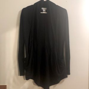 Black cardigan. Slight flair in back, pockets and a amazing slimming fit